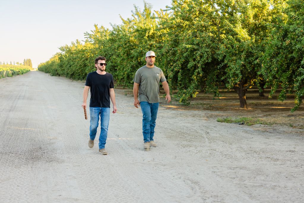 Farm family walking through an almond orchard